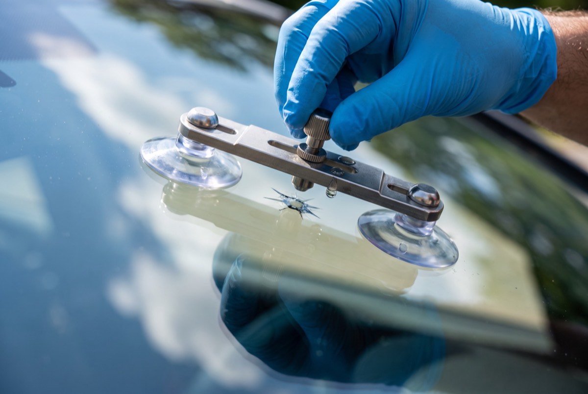 Close-up of windshield rock chip repair with a resin injector tool in Celina, TX